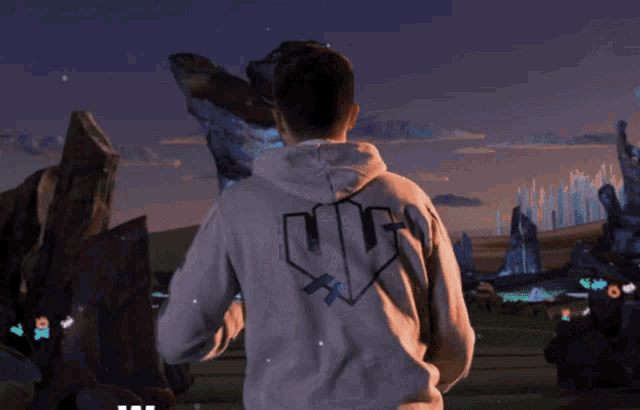a man wearing a hoodie with the word yjjiw on the back