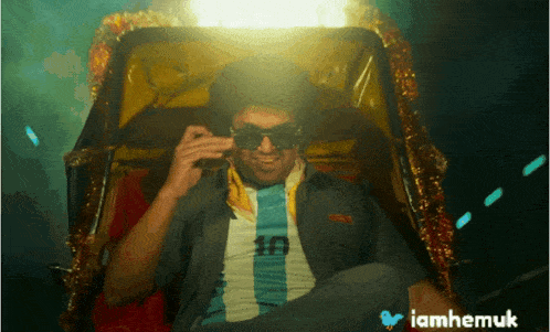 a man wearing sunglasses is sitting in a rickshaw with the hashtag iamhemuk