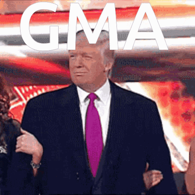 a man in a suit and tie stands in front of a gma logo