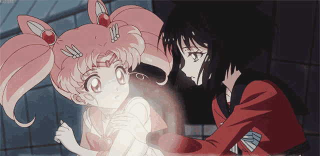 a girl in a red jacket is holding a little girl in a pink dress