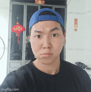 a man wearing a black shirt and a blue hat is looking at the camera with imgflip.com at the bottom