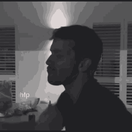 a black and white photo of a man with the letters htp on the bottom