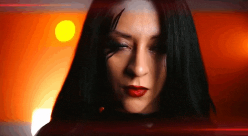 a close up of a woman 's face with red lipstick