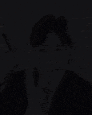 a man wearing a suit and tie is sitting in a car