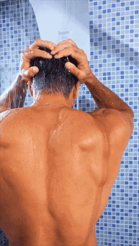 a man taking a shower with a shower head that says ' zephyr ' on it