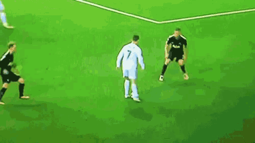 a group of soccer players are playing on a field .