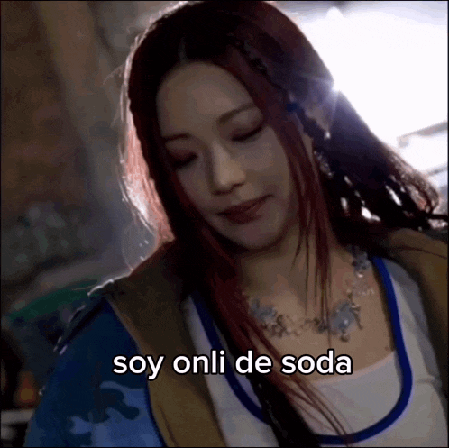 a close up of a woman with the words soy onli de soda written below her