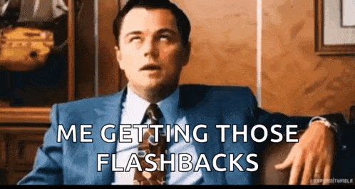 a man in a suit and tie is sitting in a chair and says `` me getting those flashbacks ''