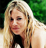 a woman with long blonde hair is smiling and looking at the camera .
