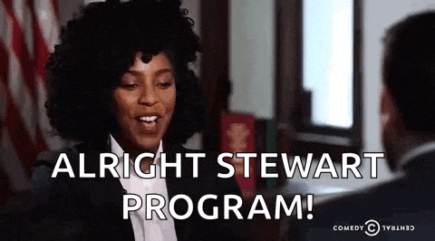 a woman is talking to a man in a suit and says `` alright stewart program ! ''