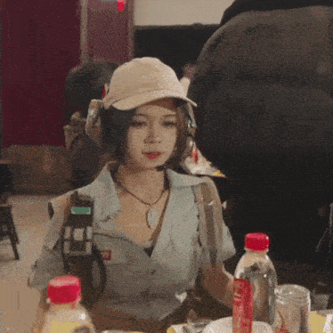 a woman wearing a hat and headphones with the word army on her shirt