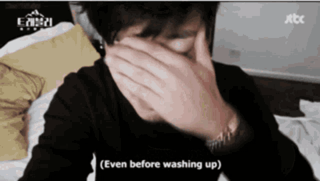 a person covering their face with their hands and the words even before washing up