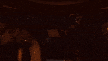 a group of soldiers are sitting in a dark room in a military vehicle .