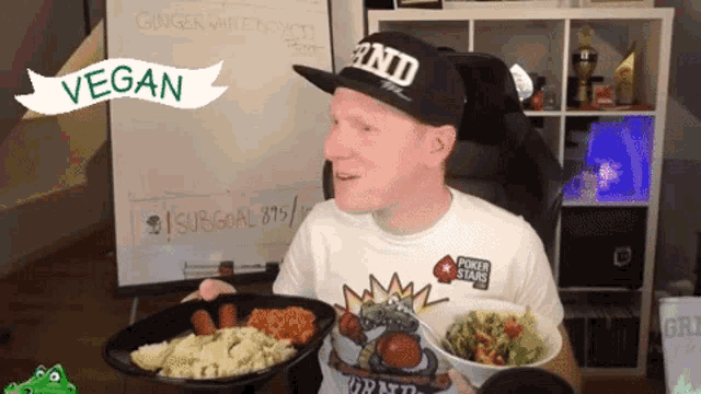 a man wearing a white shirt that says poker stars holds a plate of food