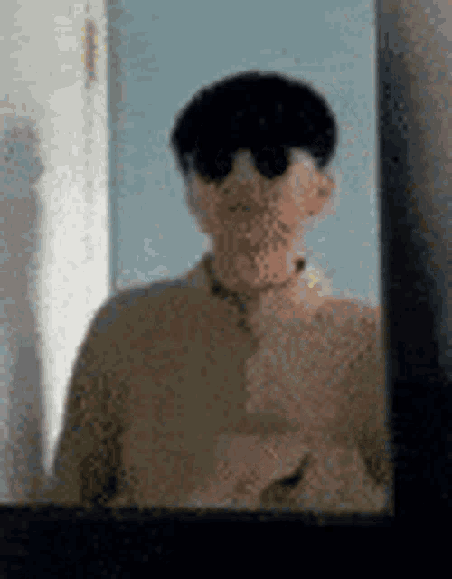a man is taking a picture of himself in a mirror .