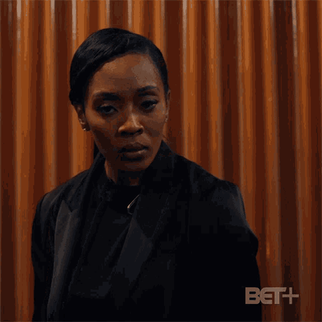 a woman in a black suit is making a face and says what ?
