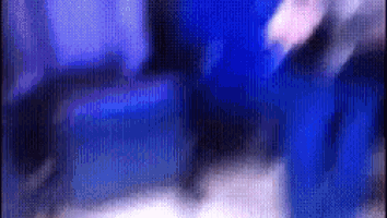 a blurry picture of a person in a blue jacket
