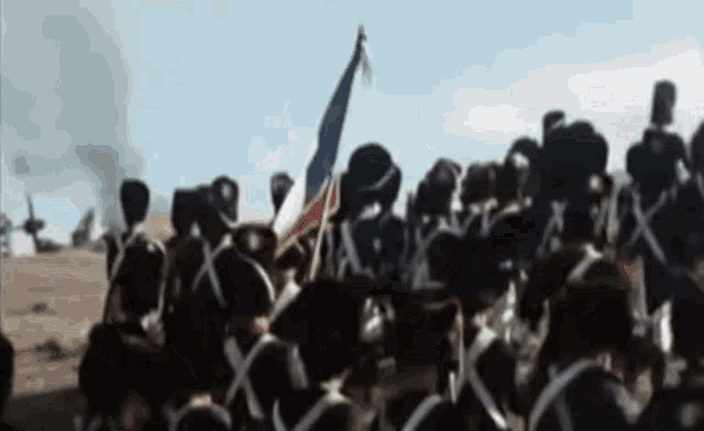 a blurred image of a group of soldiers with x 's on their helmets