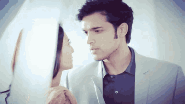 a man and woman are looking at each other