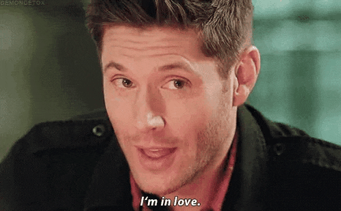 a close up of a man 's face with the words `` i 'm in love '' written on the bottom .