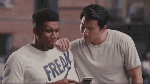 a man wearing a white shirt that says freak