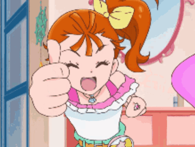 a girl with orange hair is giving a thumbs up sign
