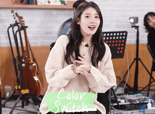 a woman wearing a sweater with the word color switch on it