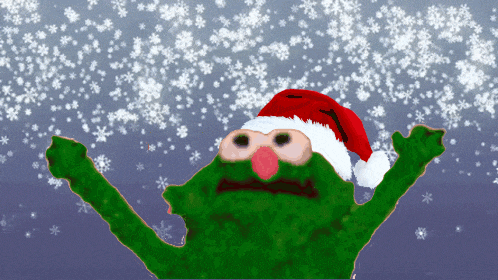 a green cartoon character wearing a santa hat with snowflakes falling around him