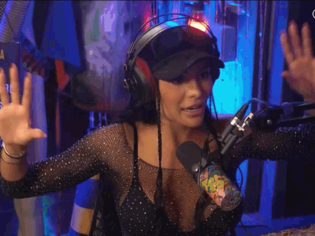 a woman wearing headphones giving a peace sign