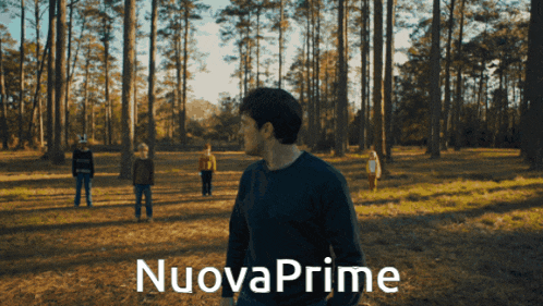 a group of people standing in a field with nuova prime written in white