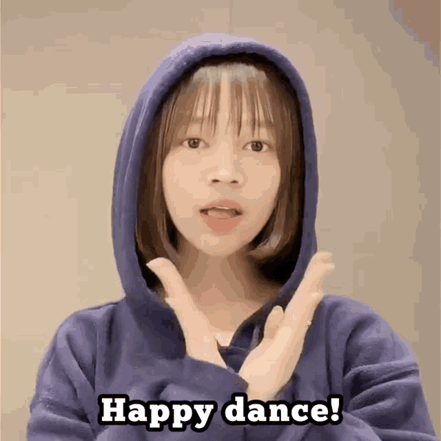 a girl wearing a blue hoodie says " happy dance "
