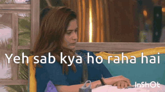 a woman sits on a couch with the words " yeh sab kya ho raha hai " written on the bottom