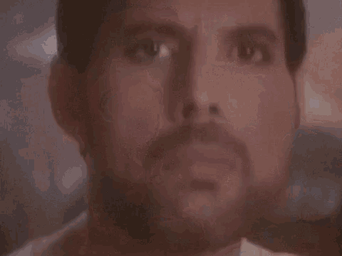a close up of a man 's face with his tongue out