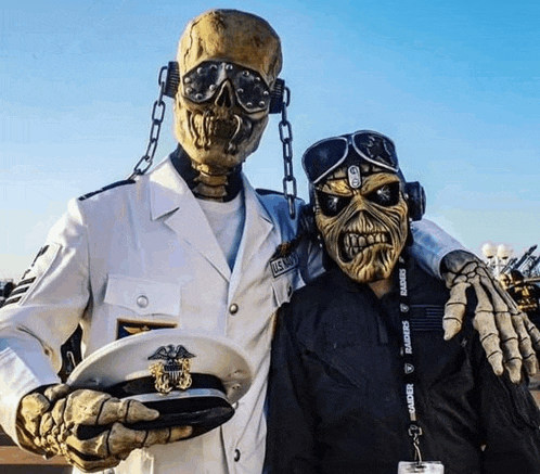 a skeleton in a military uniform poses with a man in a raiders lanyard