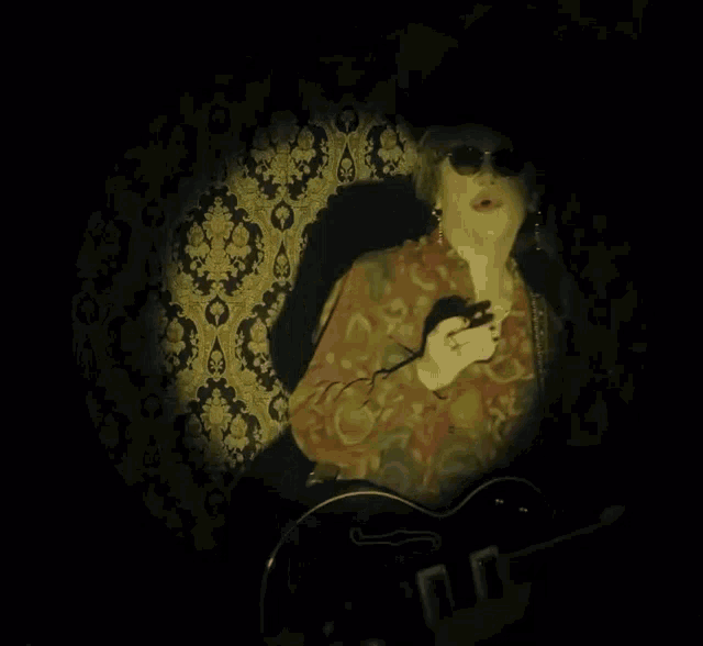 a person is playing a piano in a dark room .
