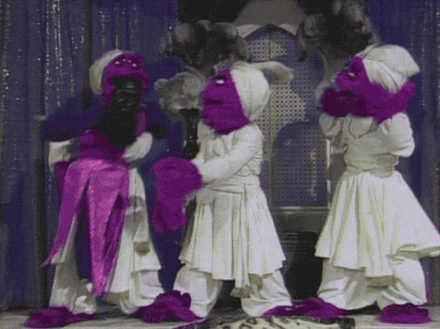 a group of sesame street characters are dancing together
