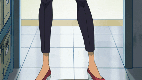 a woman wearing black pants and red shoes stands in a doorway