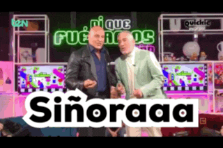 two men are standing in front of a sign that says señoraaa