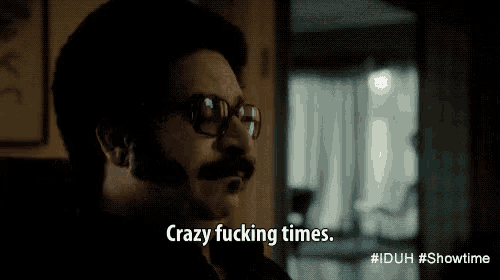 a man wearing glasses says crazy fucking times