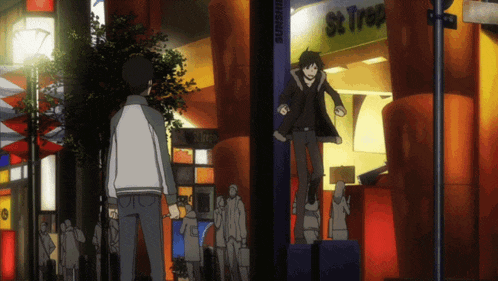 a man is standing in front of a store called st trop