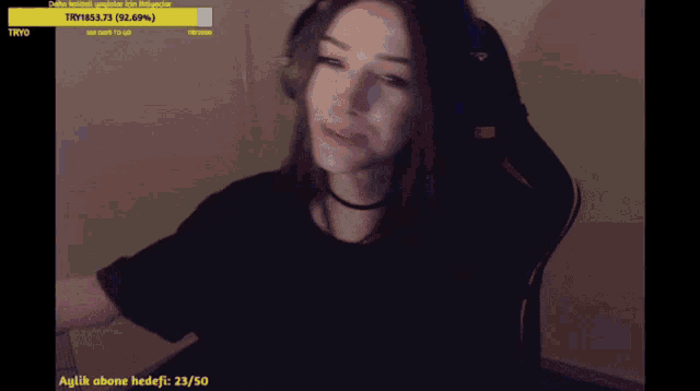 a woman wearing headphones is smiling in front of a screen that says tryo on it