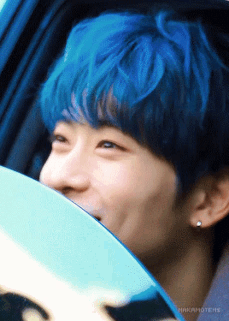 a close up of a person 's face with blue hair and a watermark that says nakamotens