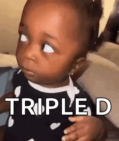 a baby girl is making a funny face and the words triple d are written on her face .