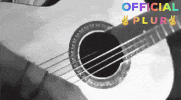 a black and white photo of a person playing an acoustic guitar with the words " official plur " in the corner