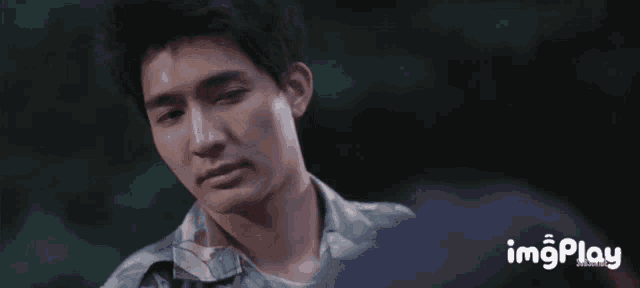 a close up of a man 's face with the words imgplay in the lower right corner