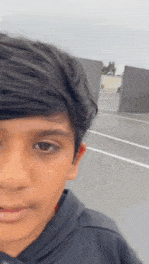 a close up of a young boy 's face with a blurred background .