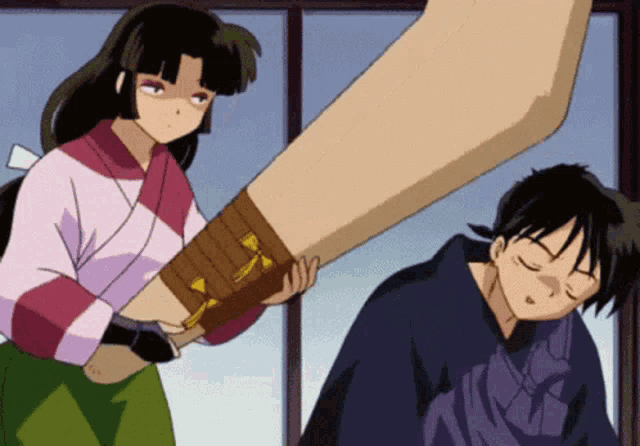 a girl is holding a sword over a boy sleeping