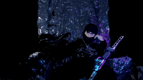 a man in a black mask holds a gun in his hand
