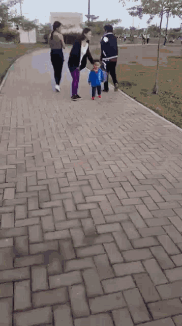 a blurry picture of a little boy running on a brick road