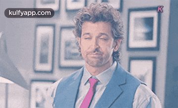 a man in a suit and tie is making a funny face ..